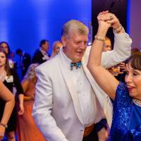 President Tom Haas dancing with guest at Enrichment